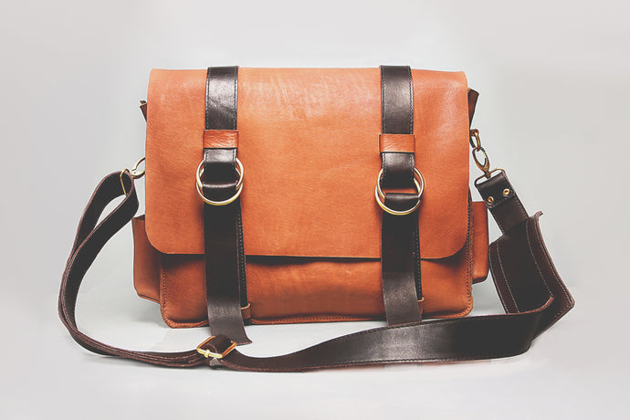 Brown authentic leather office bag, fiber handle for durability.